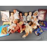 Dolls - A collection of ten jointed baby faced dolls included in the lot are doll collecting books.