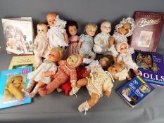 Dolls - A collection of ten jointed baby faced dolls included in the lot are doll collecting books.
