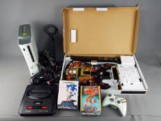 Xbox 360, Sega, Playstation - A mixed group of gaming equipment.