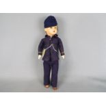 SFBJ Jumeau - A SFBJ composition faced boy doll dressed in a blue felt uniform with metal buttons,