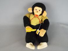 Zippy - A vintage Zippy chimpanzee toy with banana in hand, yellow and black body,