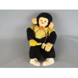 Zippy - A vintage Zippy chimpanzee toy with banana in hand, yellow and black body,