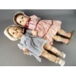 Roddy Dolls - A pair of walking Roddy Dolls with stands consisting of a baby Roddy Doll with