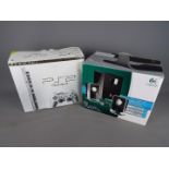 Sony, Logitech - A boxed Sony PS2 console and controllers,