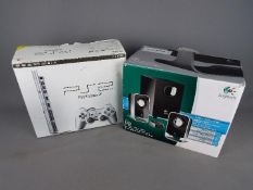 Sony, Logitech - A boxed Sony PS2 console and controllers,