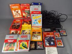 Atari - A vintage unboxed Atari 2600 console, owners manual,