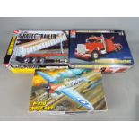 Academy, AMT - Three boxed plastic model kits in various scales.