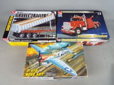 Academy, AMT - Three boxed plastic model kits in various scales.