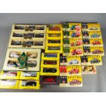 Vanguards, Lledo, Maisto - A collection of boxed diecast model vehicles in various scales.