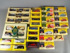 Vanguards, Lledo, Maisto - A collection of boxed diecast model vehicles in various scales.