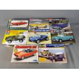 AMT, MPC - Eight boxed plastic model car kits in various scales.