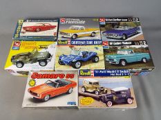 AMT, MPC - Eight boxed plastic model car kits in various scales.