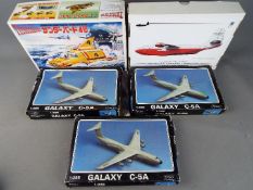 Aoshima - A group of five boxed model kits in various scales.