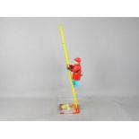 Marx - An unboxed tinplate and plastic 'Climbing Fireman' by Marx. The toy is in Playworn condition.