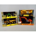 Ertl - A collection of four boxed diecast construction vehicles in 1:50 scale by Ertl.