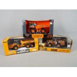 Ertl - A collection of three boxed diecast construction vehicles in 1:50 scale by Ertl.