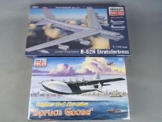 Minicraft Model Kits - a collection of two all plastic model kits to include a Hughes F-4 Hercules