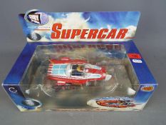 Gerry Anderson - a Gerry Anderson Diecast Classics Supercar in red and blue by Product Enterprise