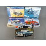 Five boxed model kits in varying scales by Tamiya, Revell,