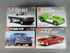 AMT - Four boxed plastic model car kits by AMT.