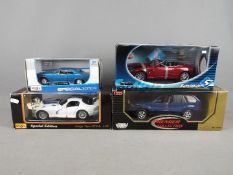 Maisto, Motor Max, Solido - Four boxed diecast vehicles in 1:18 and 1:24 scale.