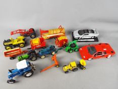 Lot to include a quantity of unboxed, playworn model farm vehicles / implements by Britains,