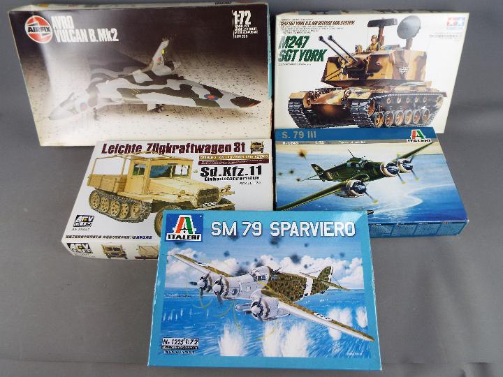 A selection of unassembled model kits including Italeri, Tamiya,