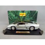 A boxed 1:12 scale Jaguar XJ220 (1992) in silver, model appears in VG condition but dusty, box VG.