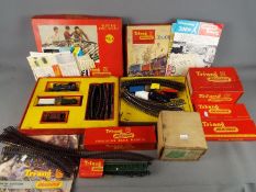 Triang - A vintage suitcase containing a mainly boxed collection of Triang OO gauge model railway