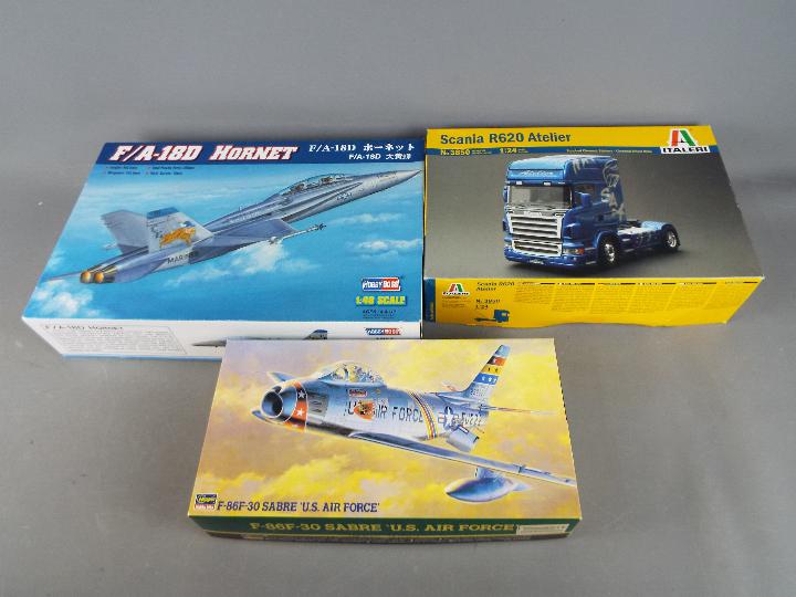 Three boxed model kits comprising a 1:48 scale Hobby Boss F/A-18D Hornet,