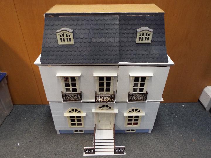 A three storey doll's house, with various good quality furniture,