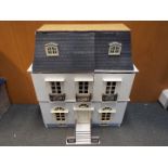 A three storey doll's house, with various good quality furniture,