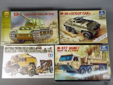 Four boxed model kits of military vehicles by Tamiya, Zvezda and Italeri,