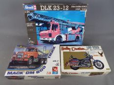 Three boxed model kits in varying scales to include an IMAI Harley-Davidson Low Rider,