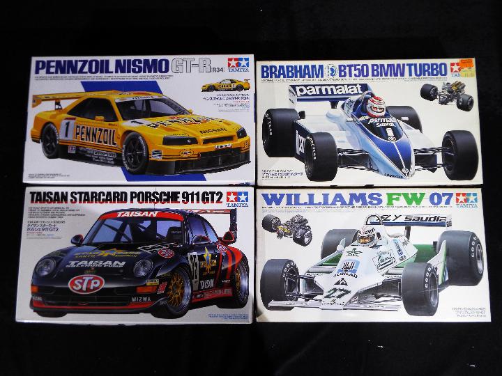 Tamiya - Four boxed 1:20 and 1:24 scale midel kits of racing cars comprising Brabham BT50 BMW Turbo,