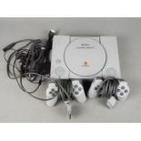 Sony - An unboxed Sony Playstation console with power supply and two controllers.