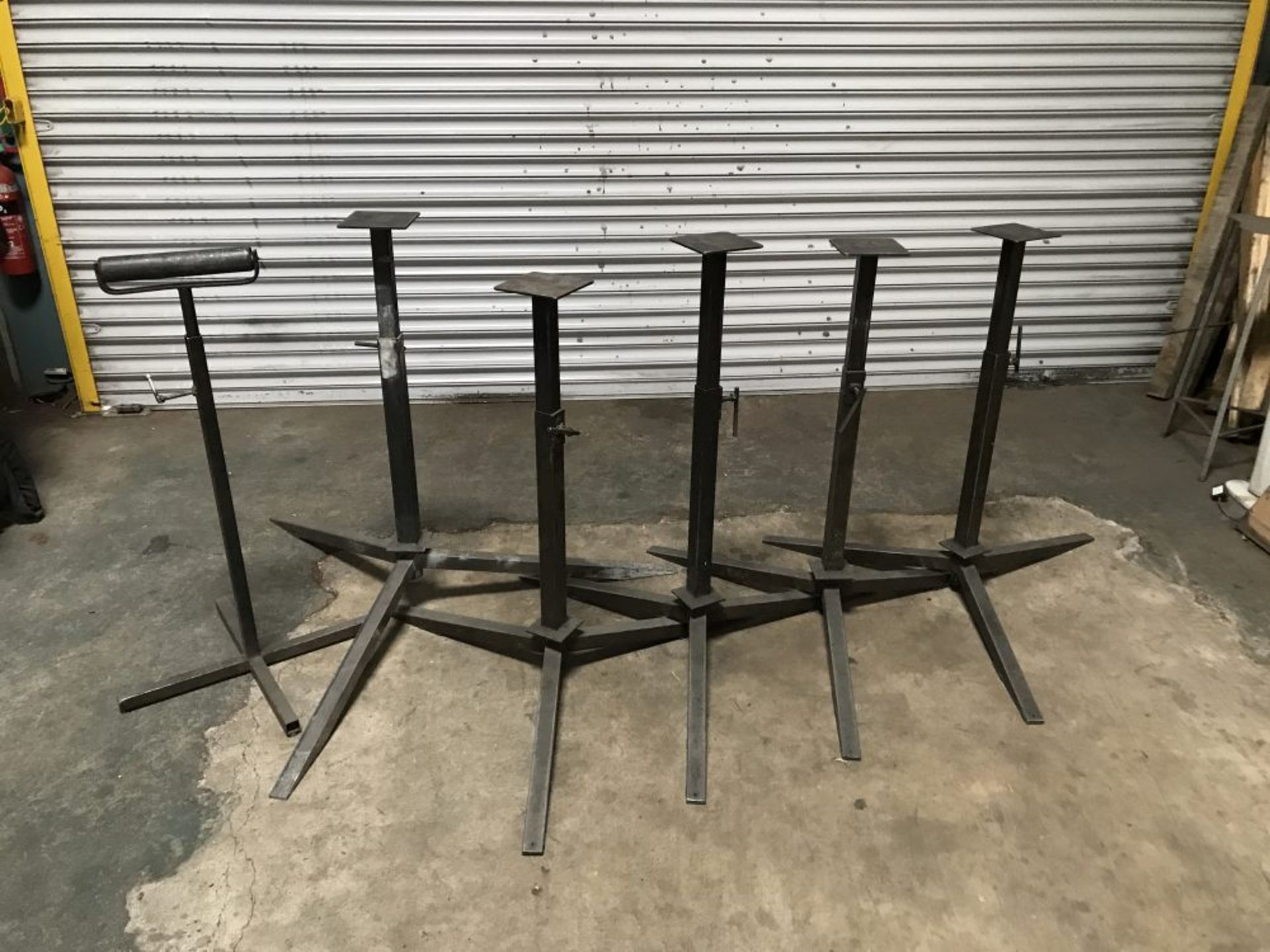 7 adjustable height heavy duty steel tripod stands and a roller stand - Image 2 of 2