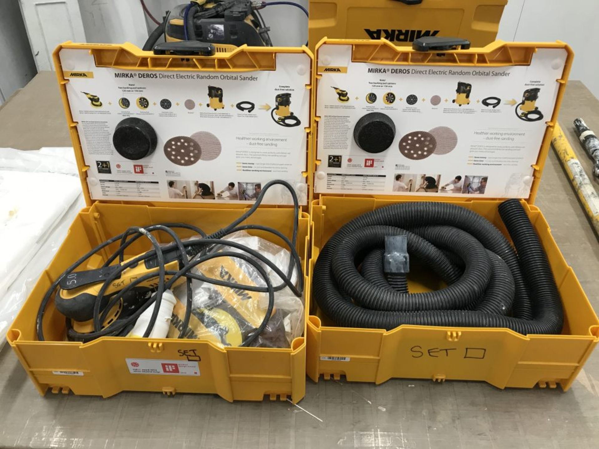 2 Mirka DEROS 650X sanders with 3 cases and one section of hose