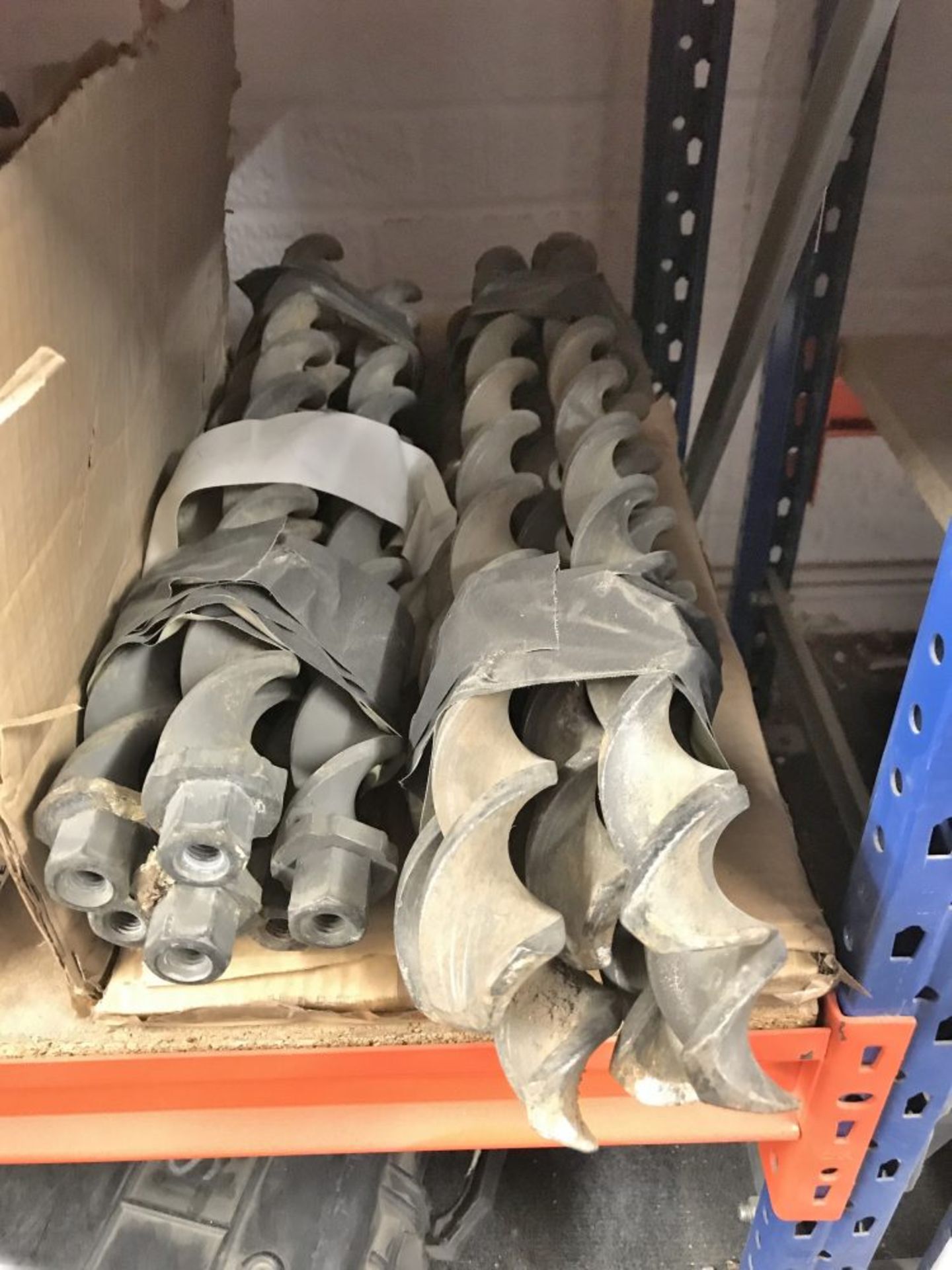 A quantity of large drill bits