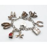 Silver charm bracelet with 8 charms and heart clasp, weight 35.6g