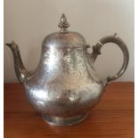 Antique Victorian silver teapot, having scroll handle and hinged dome lid, bulbous shape with