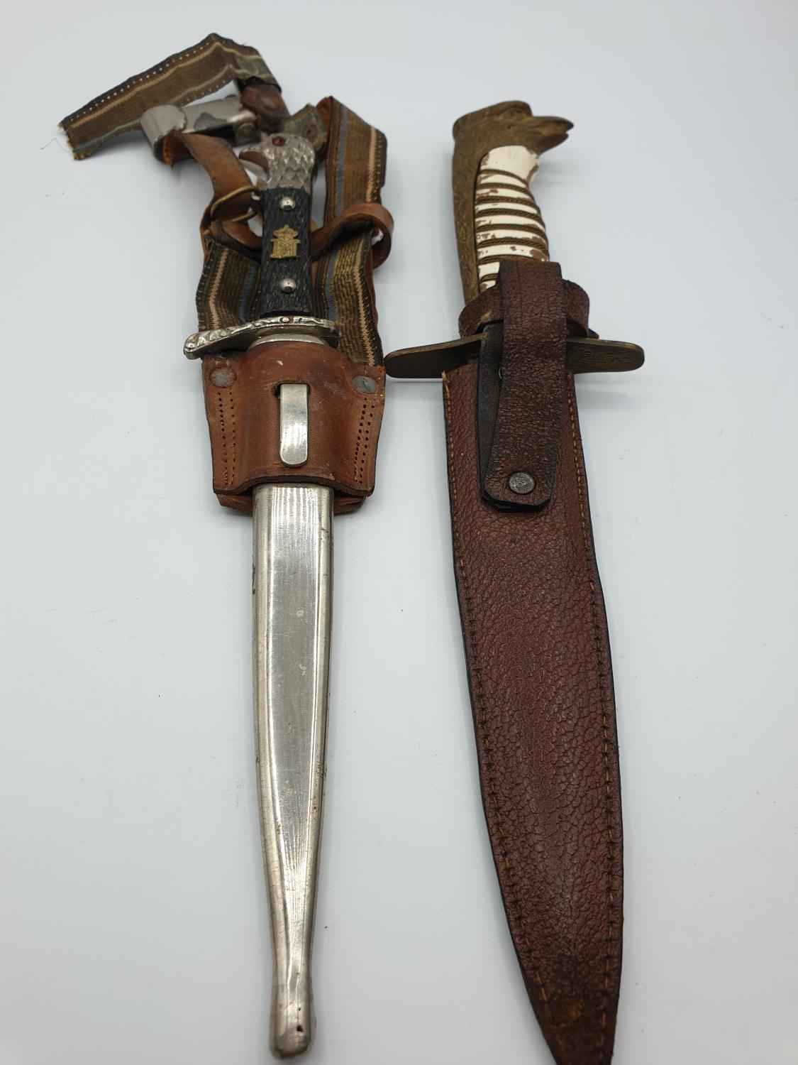 2 military daggers unknown origins, one with hangers