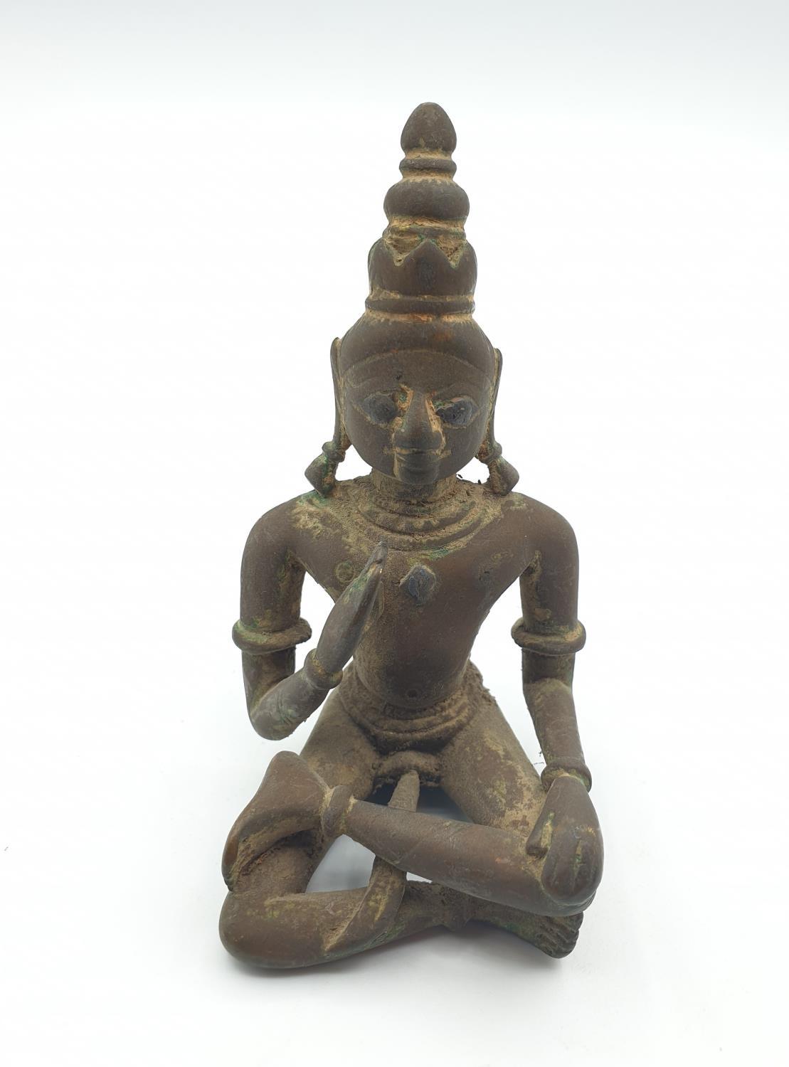 Late 18th century Oriental religious figure in bronze with gilt finish mostly worn off with age, 9cm
