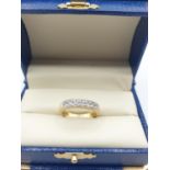 18K gold half eternity ring with a row of seven diamonds London hallmark, size N.