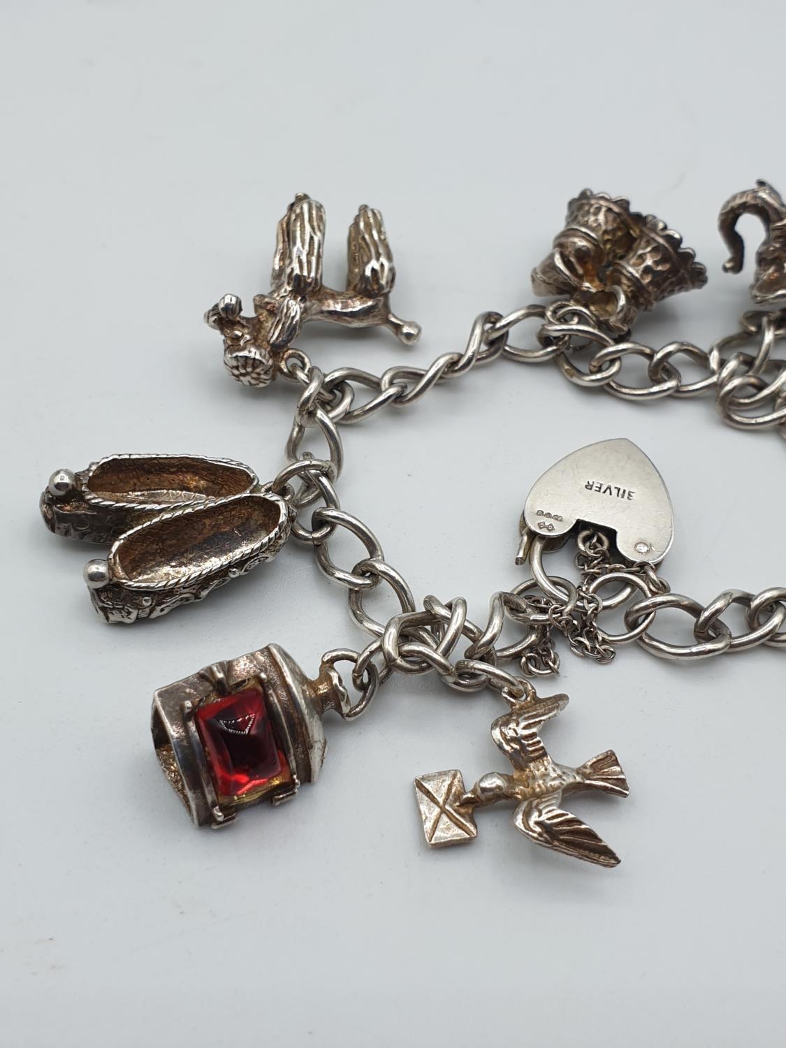 Silver charm bracelet with 8 charms and heart clasp, weight 35.6g - Image 2 of 3