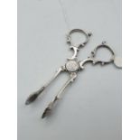 Pair of silver scissor tongs with shell shaped pincers made in Birmingham dated 1875, weight 33g and
