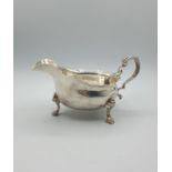 Antique Silver Sauce/ Gravy boat with three cabriole legs and having an unusual scaled design rim.