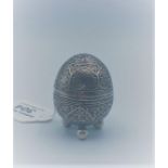 An engraved silver egg shaped cruet with ball feet, weight 57g and 6cm tall