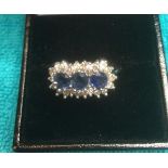 18ct white gold ring with sapphire trilogy and diamond surround, sapphires total 1ct and diamond