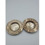 Pair of silver dip dishes, coaster size with ornate borders, central American, base showing Silver